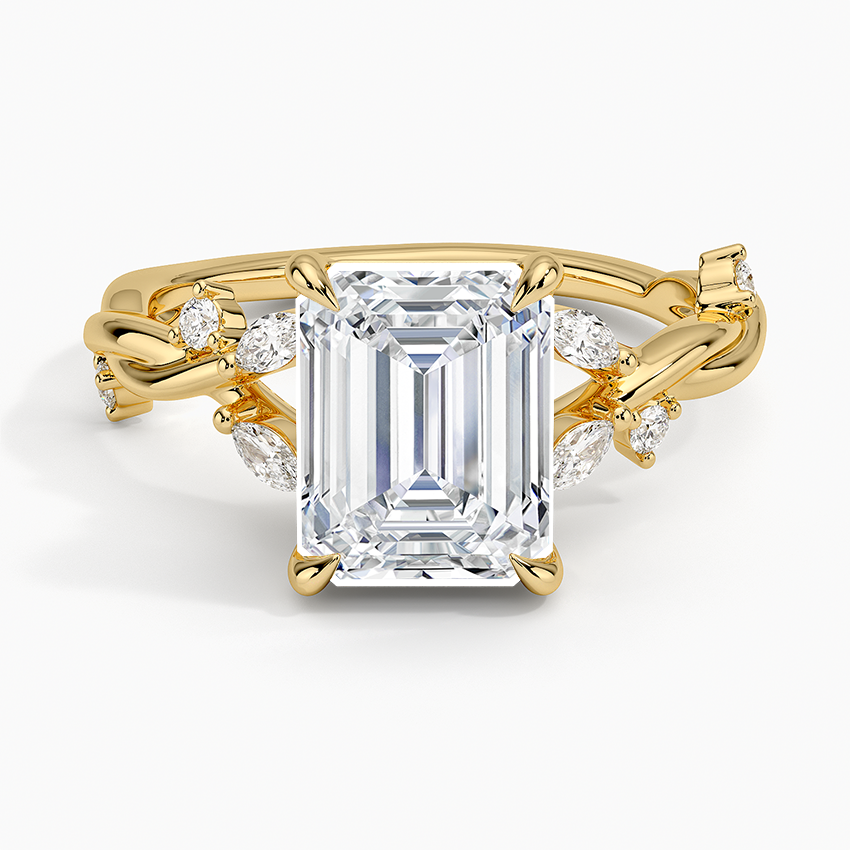 Emerald cut lab grown diamond ring in yellow gold with marquise and round diamonds scattered along a twisted vine, top view