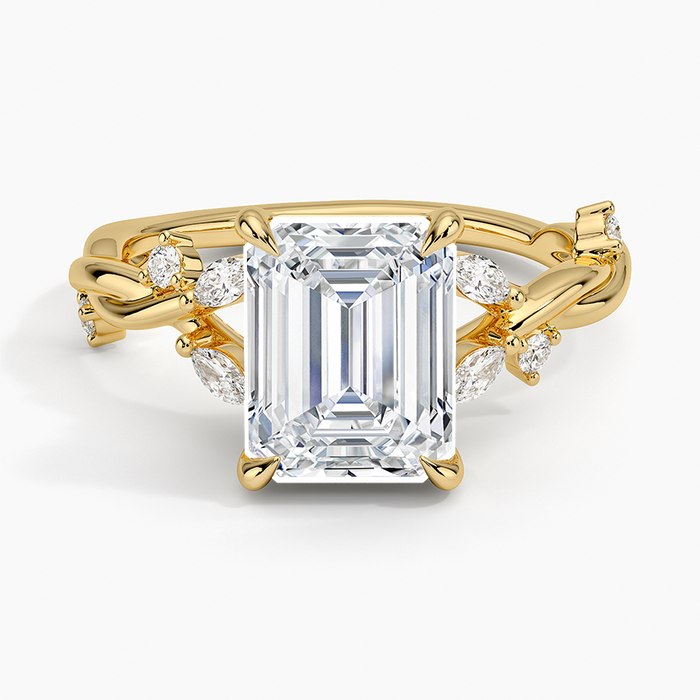 Emerald cut lab grown diamond ring in yellow gold with marquise and round diamonds scattered along a twisted vine, top view