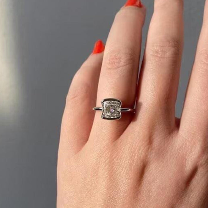 Half bezel wrapping two sides of the cushion cut lab grown diamond