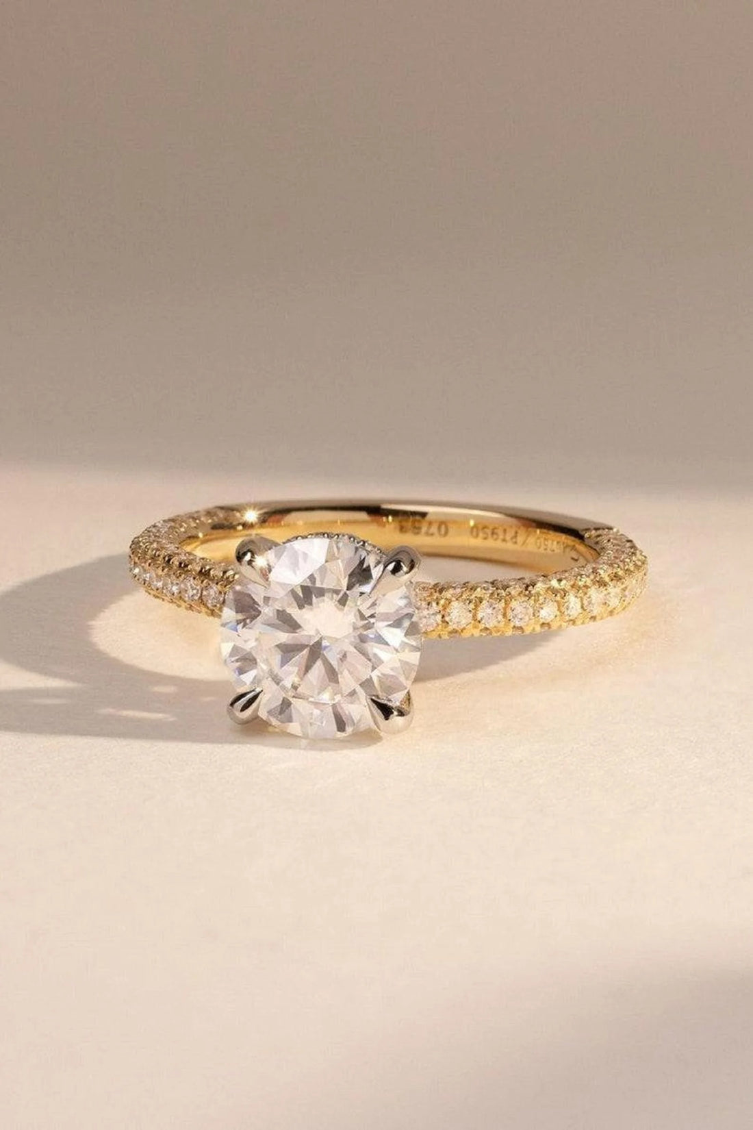 Round cut lab grown diamond engagement ring with pave band in yellow gold