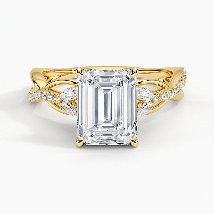 Emerald cut lab grown diamond ring in yellow gold with marquise leaf accents on a twisted pave vine, top view