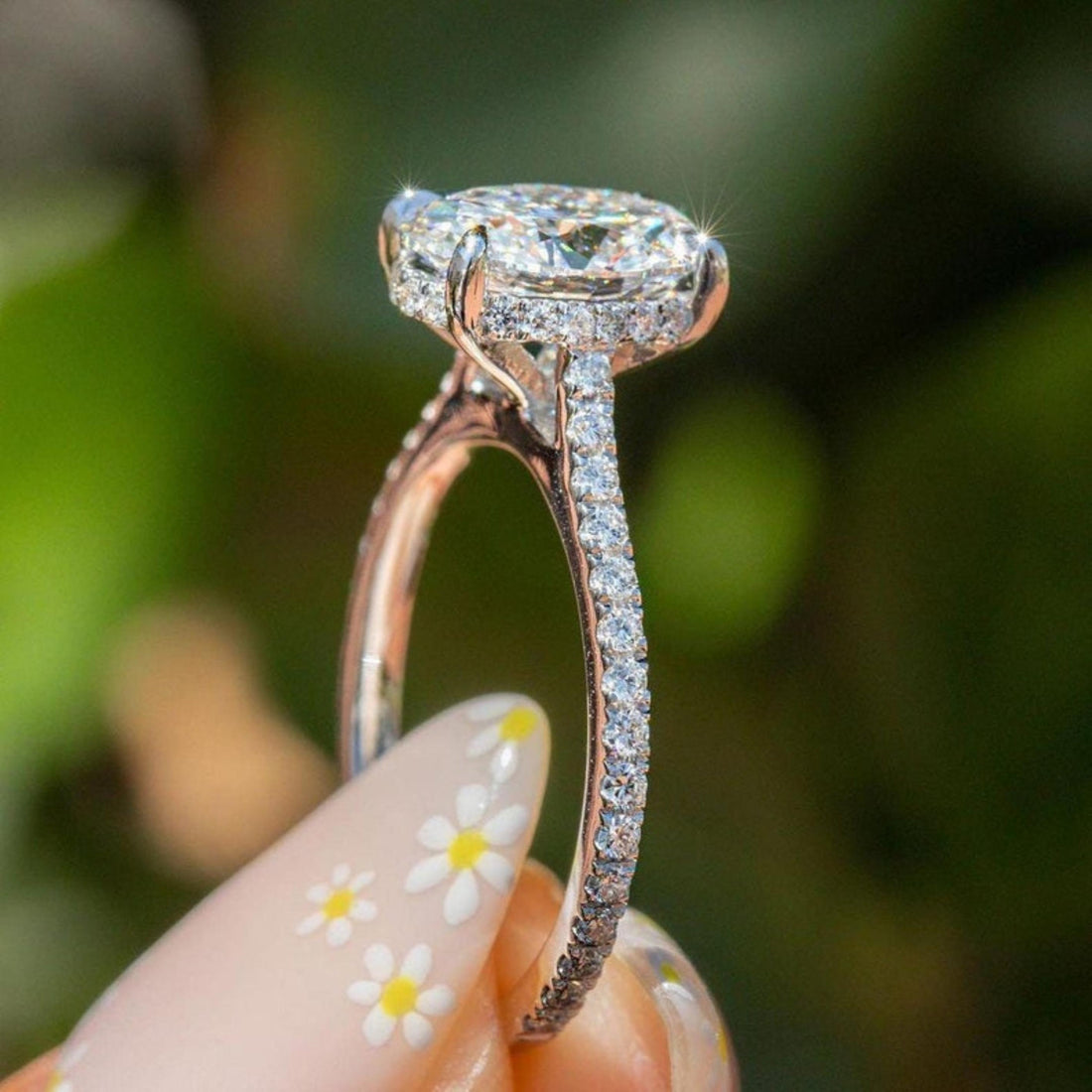 Oval cut lab grown diamond cathedral engagement ring with hidden halo and pave band