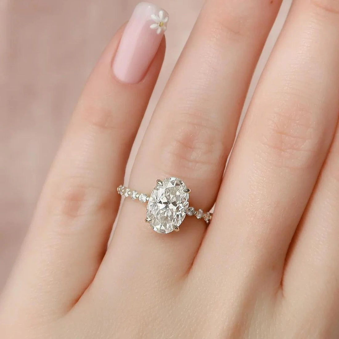 Oval cut lab grown diamond engagement ring with shared prong diamond band