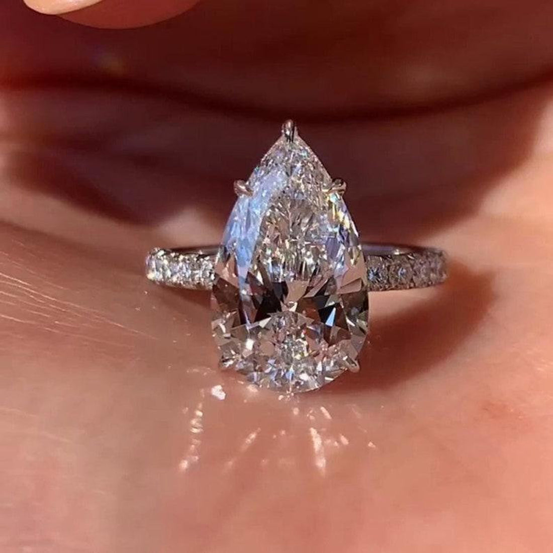 Pear cut lab grown diamond tear drop ring with hidden halo and pave