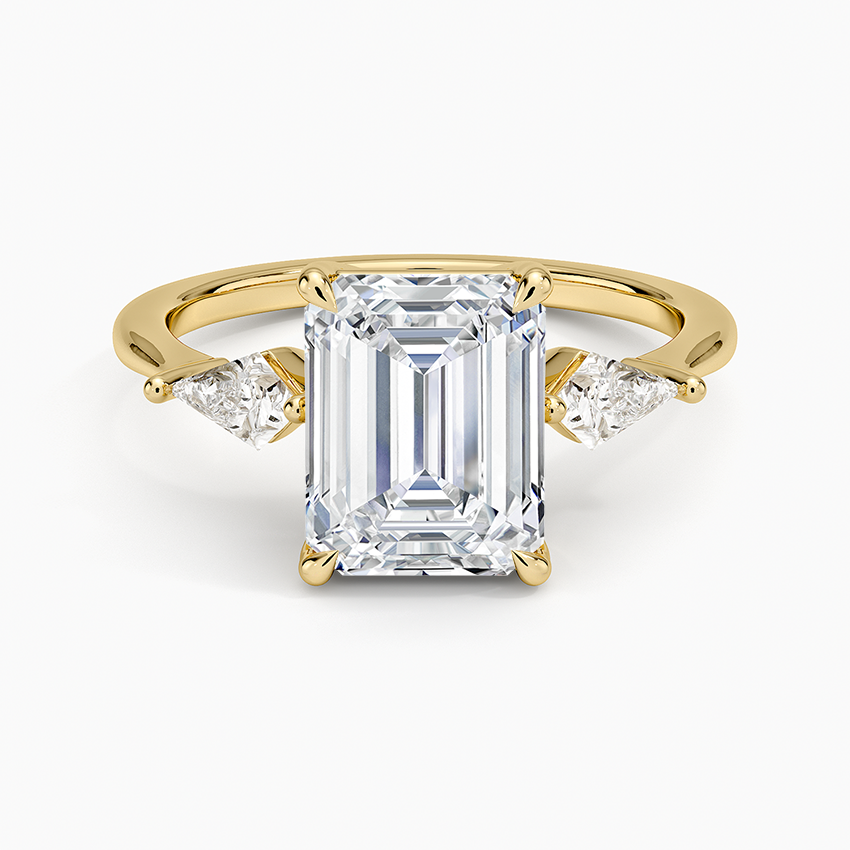 Emerald cut lab grown diamond ring in yellow gold with trillion cut side stones, top view