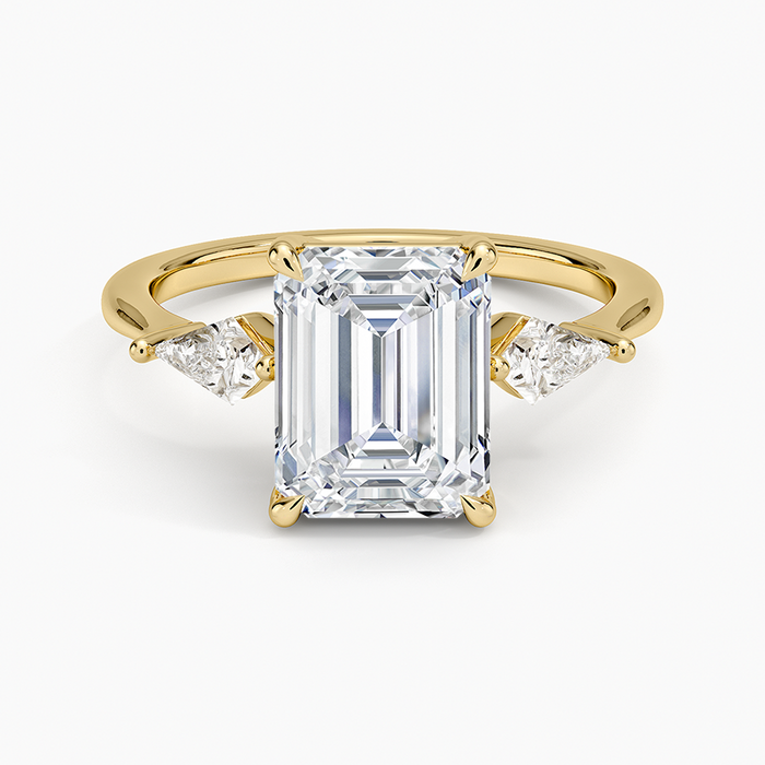 Emerald cut lab grown diamond ring in yellow gold with trillion cut side stones, top view
