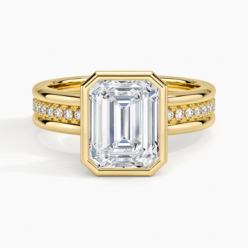 Emerald cut lab grown diamond ring in a full yellow gold bezel on a triple row pave band, top view
