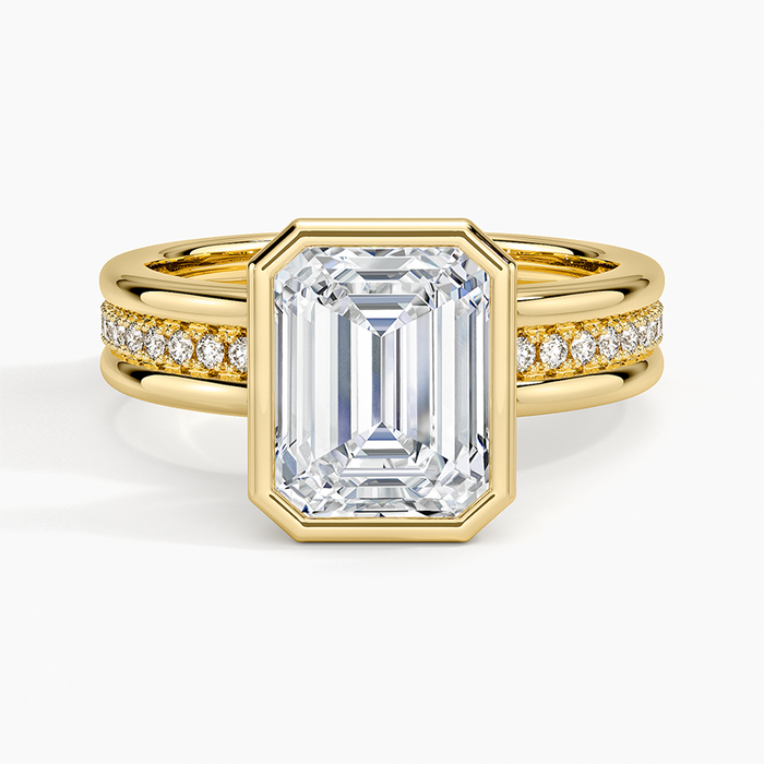 Emerald cut lab grown diamond ring in a full yellow gold bezel on a triple row pave band, top view