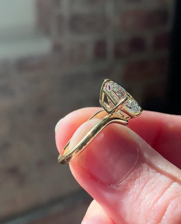 Square step cut Asscher lab grown diamond in four prongs on a plain band