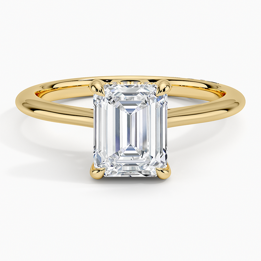 Emerald cut lab grown diamond ring with hidden halo and plain domed yellow gold band, top view