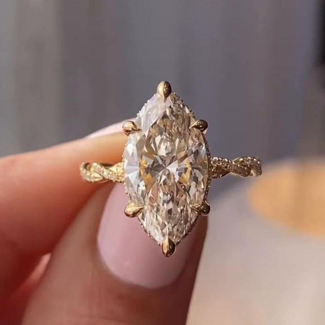 Marquise cut lab grown diamond engagement ring with hidden halo on a twisted shank