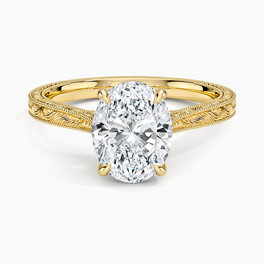 Oval cut lab grown diamond ring on a hand engraved scroll and milgrain yellow gold band, top view