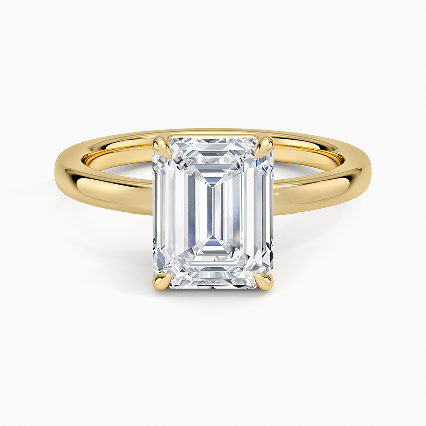 Emerald cut lab grown diamond solitaire ring in yellow gold with tapered half round band, top view
