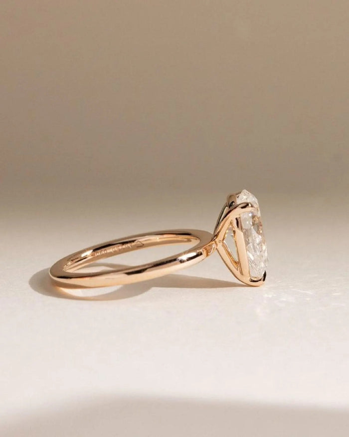 Pear cut lab grown diamond held in five prongs on a plain shank