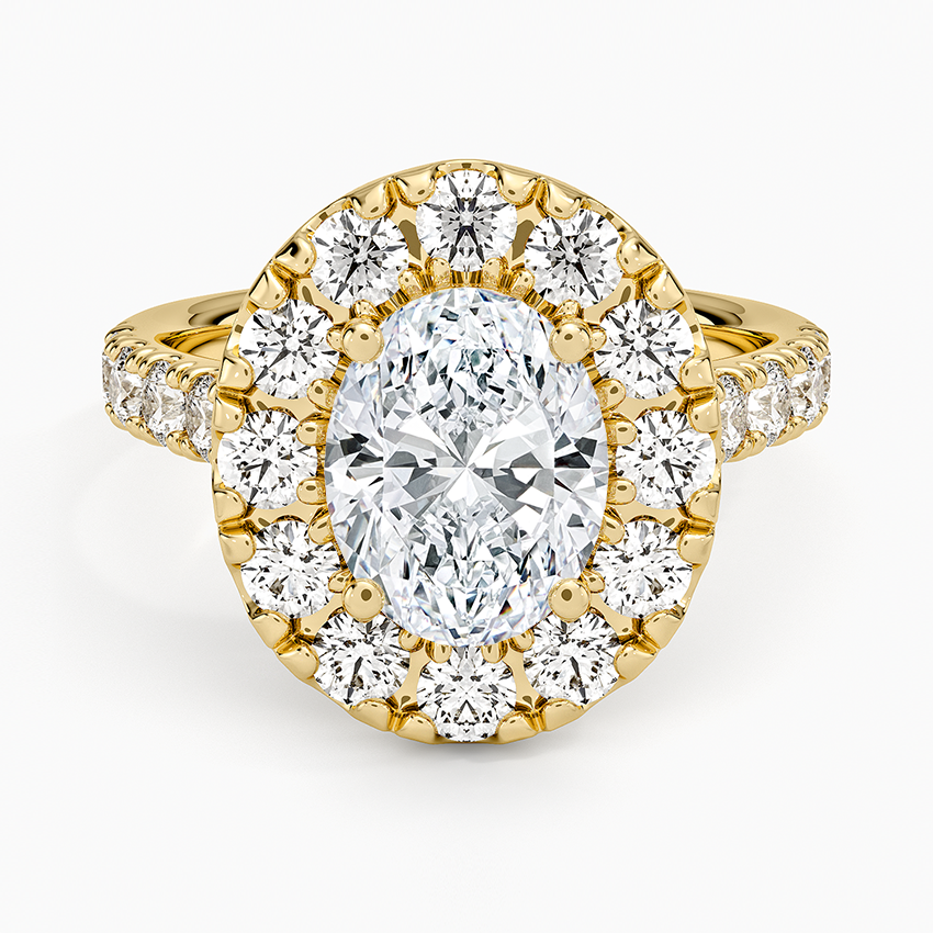 Oval cut lab grown diamond ring with a large stone halo on an overhanging plate in yellow gold, top view