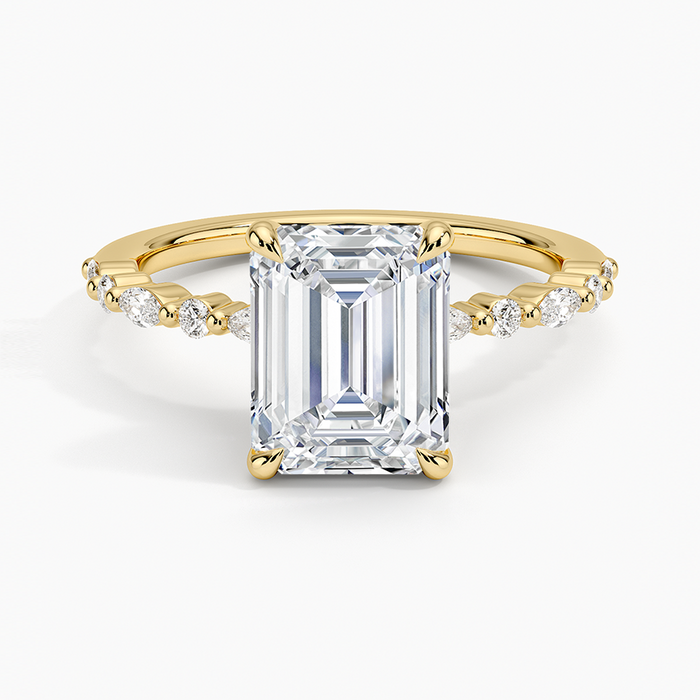 Emerald cut lab grown diamond ring in yellow gold with spaced marquise and round accent diamonds, top view