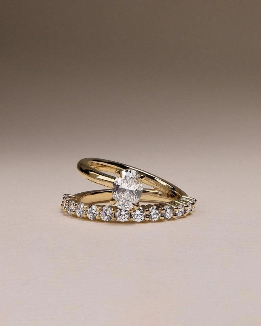 Oval cut lab grown diamond bridal ring set with pave wedding band in yellow gold