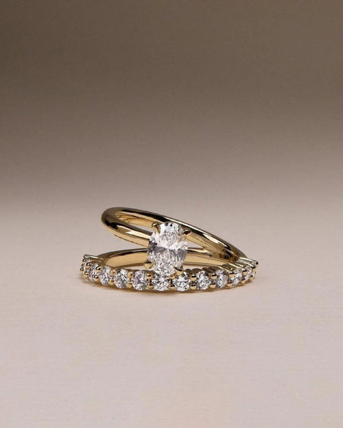 Oval cut lab grown diamond bridal ring set with pave wedding band in yellow gold