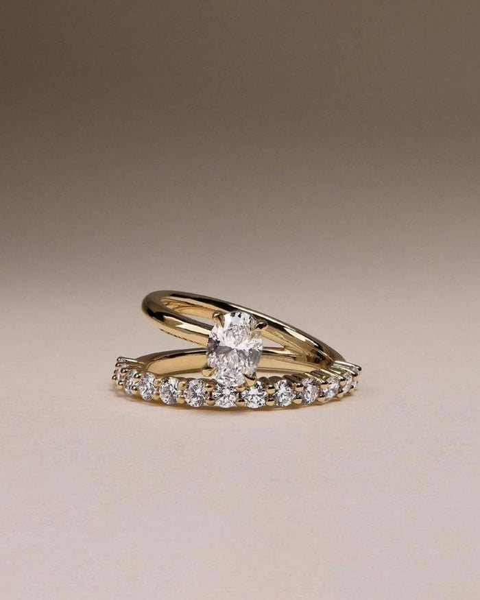 Oval cut lab grown diamond bridal ring set with pave wedding band in yellow gold