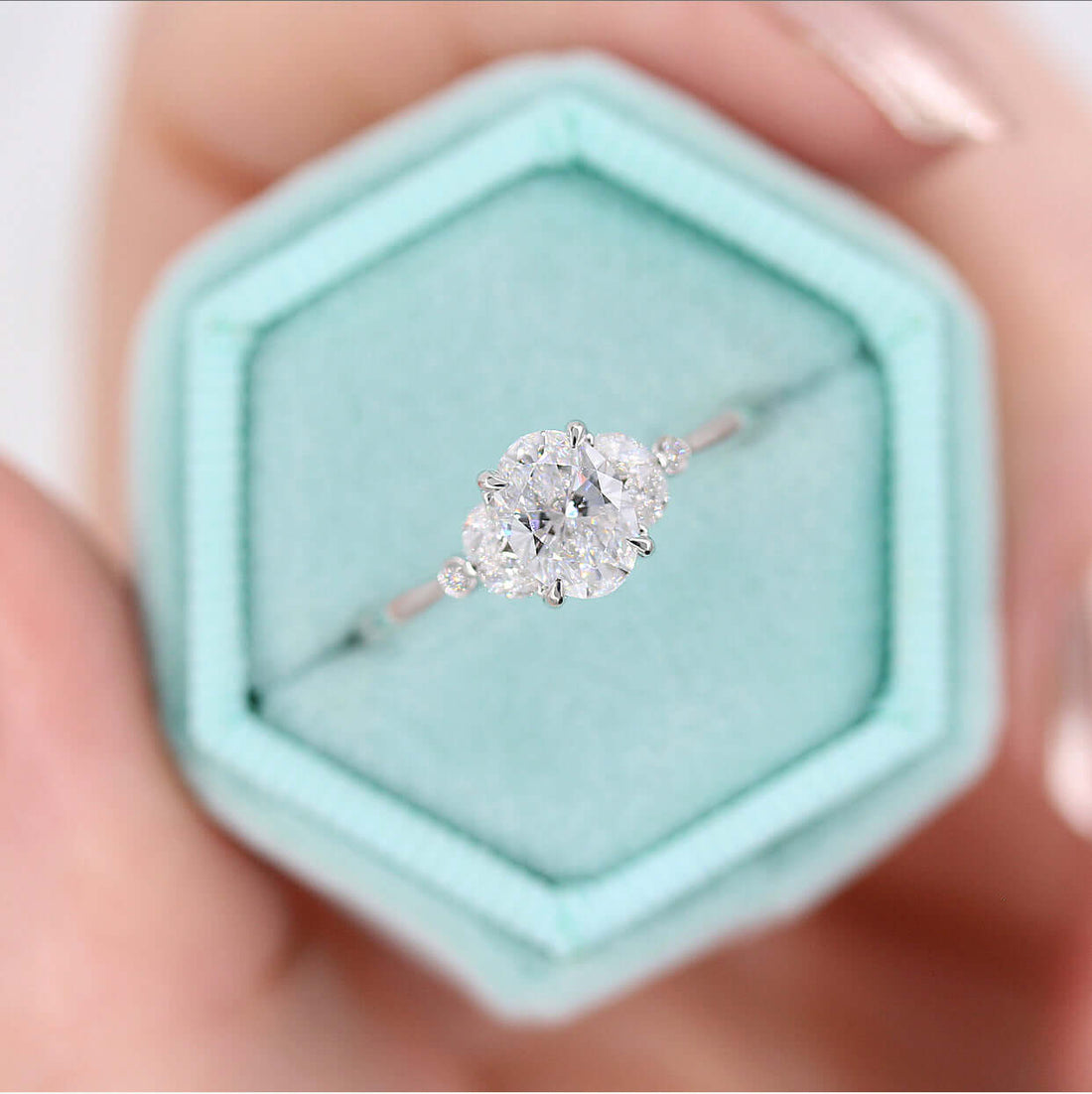 Oval lab grown diamond ring with marquise and dot side clusters