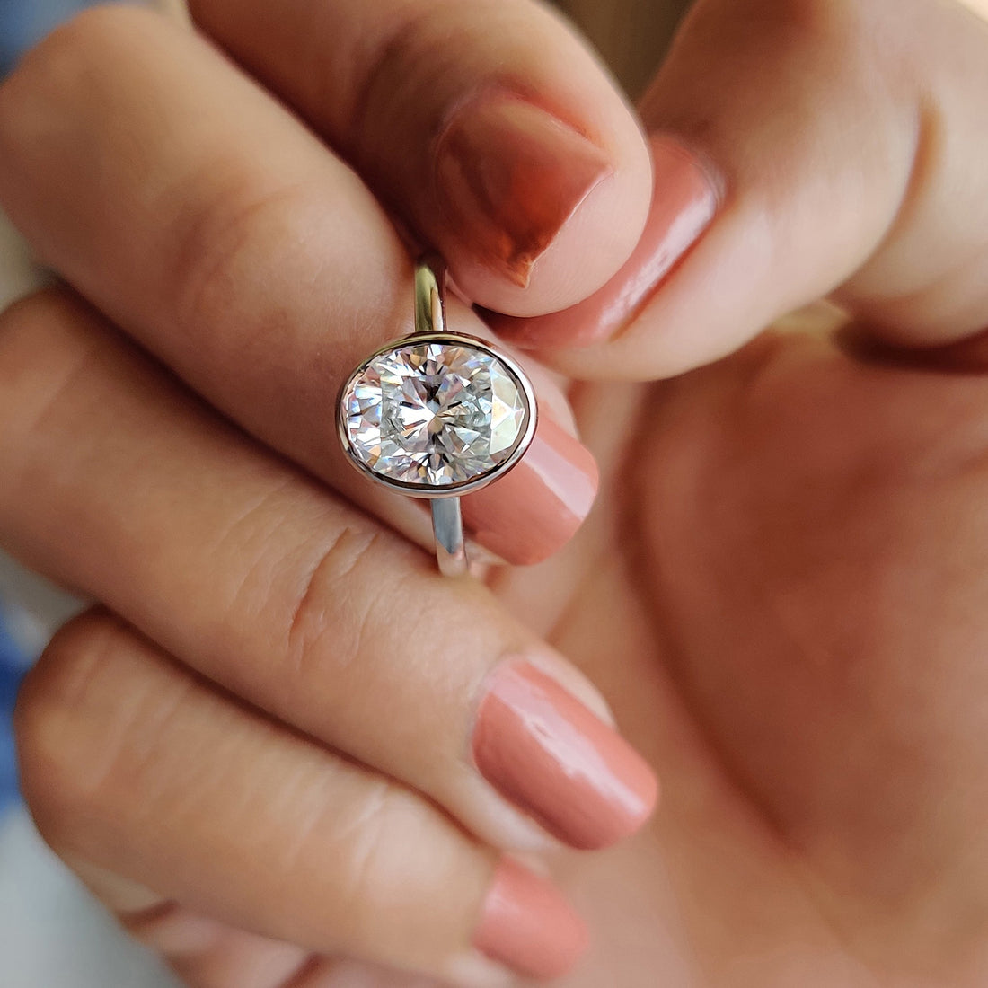 Oval cut lab grown diamond bezel solitaire ring