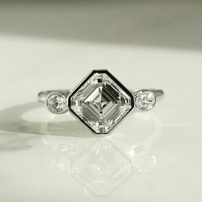 Asscher cut lab grown diamond in a full bezel with round bezel set accents