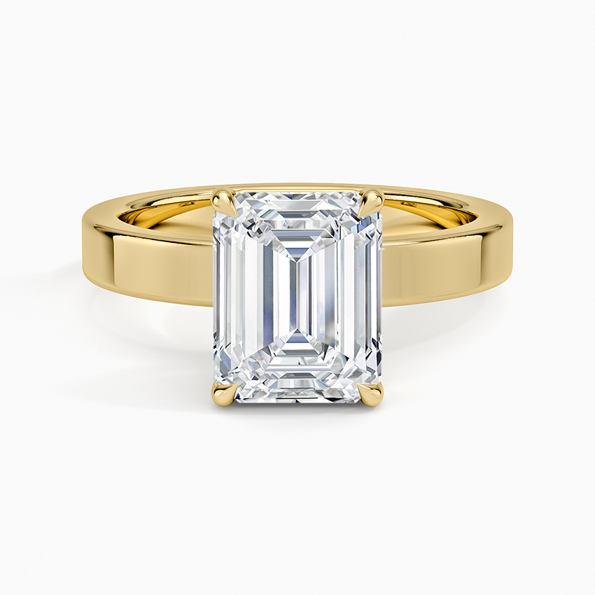 Emerald cut lab grown diamond ring in yellow gold on a flat squared band, top view
