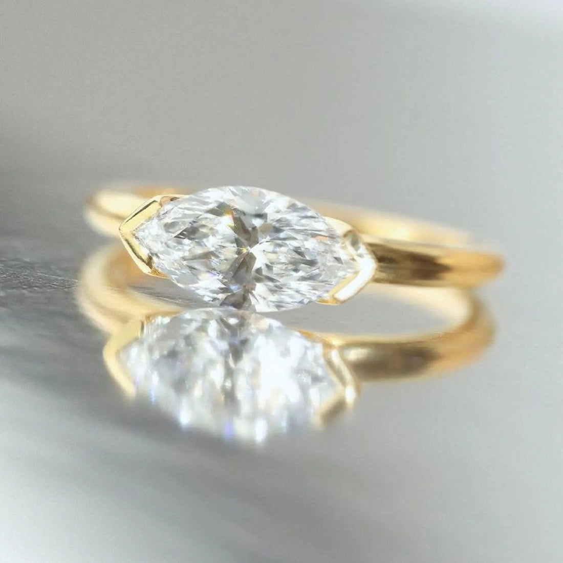 East west marquise cut lab grown diamond engagement ring in yellow gold