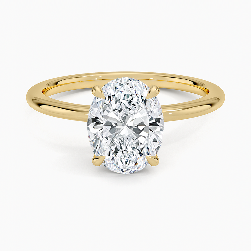 Oval cut lab grown diamond solitaire ring on a slim plain yellow gold band, top view