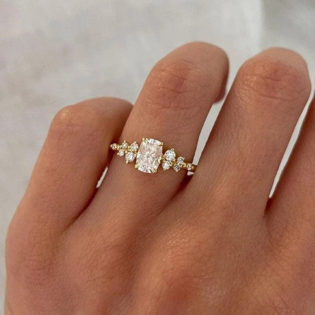 Cushion cut lab grown diamond engagement ring with scattered cluster accents in yellow gold
