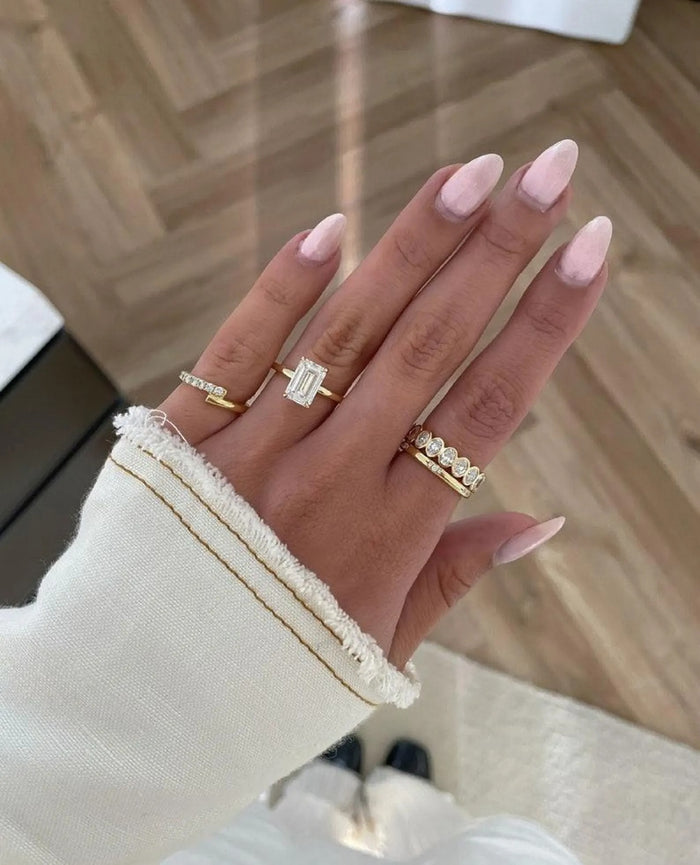 Elongated emerald cut lab grown diamond ring shown on the hand