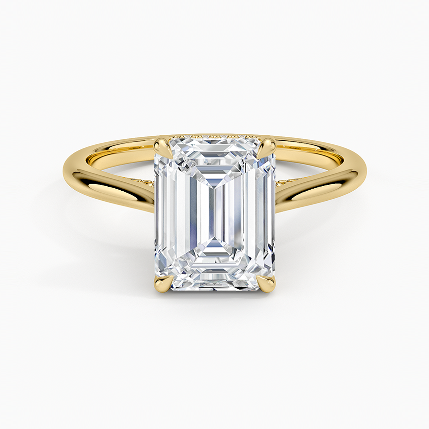 Emerald cut lab grown diamond ring in yellow gold on a plain tapered band, top view