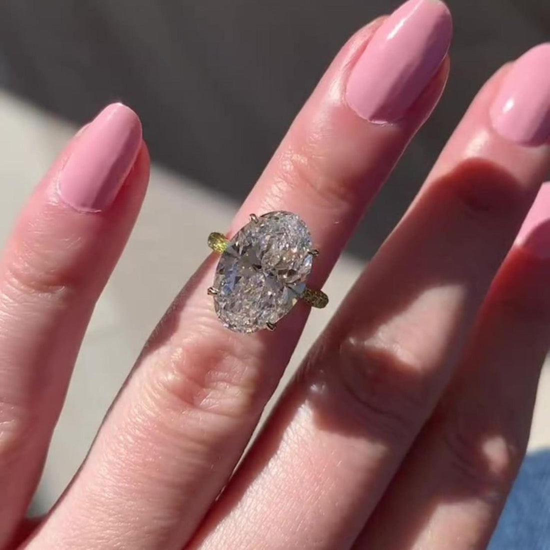 Oval cut lab grown diamond engagement ring with hidden halo, claw prongs and eternity band