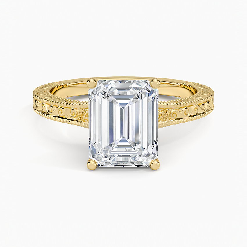 Emerald cut lab grown diamond ring in yellow gold on a carved filigree band with milgrain edges, top view