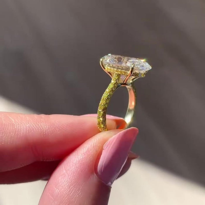 Tapered claw prongs holding the oval lab grown diamond centre stone