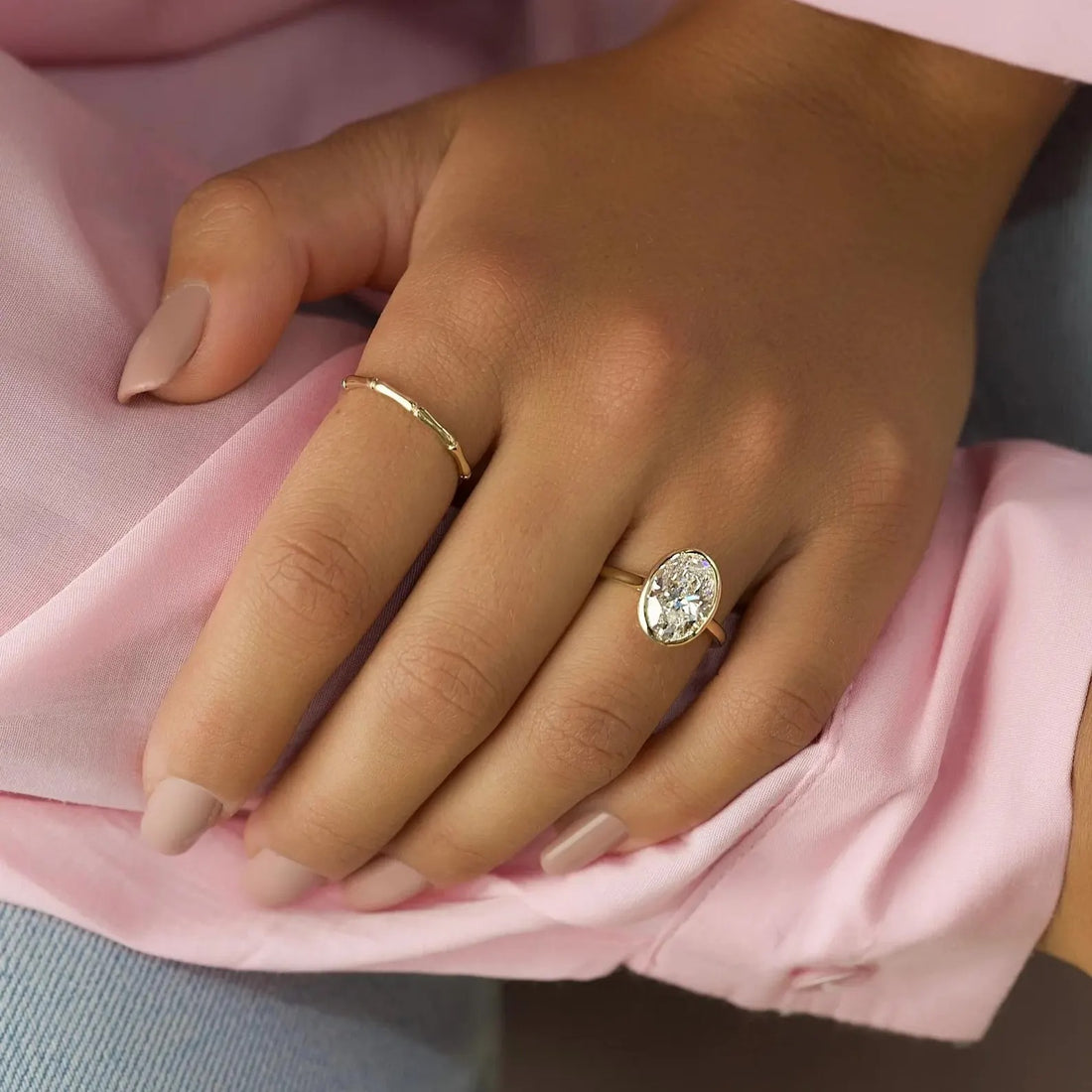Oval cut lab grown diamond engagement ring on an ultra thin yellow gold band