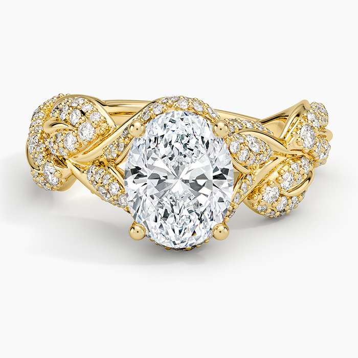 Oval cut lab grown diamond ring with pave filled leaves on an interwoven vine in yellow gold, top view