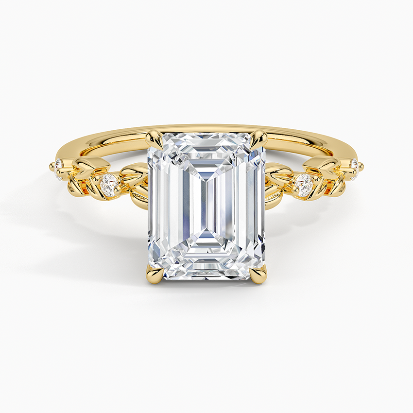 Emerald cut lab grown diamond ring in yellow gold with carved metal leaves and diamond buds along the band, top view