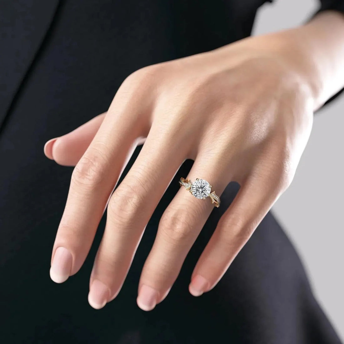 Round cut lab grown diamond engagement ring with marquise leaf accents shown on the hand