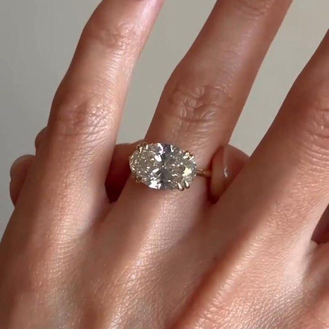 Oval cut lab grown diamond double prong engagement ring with hidden halo