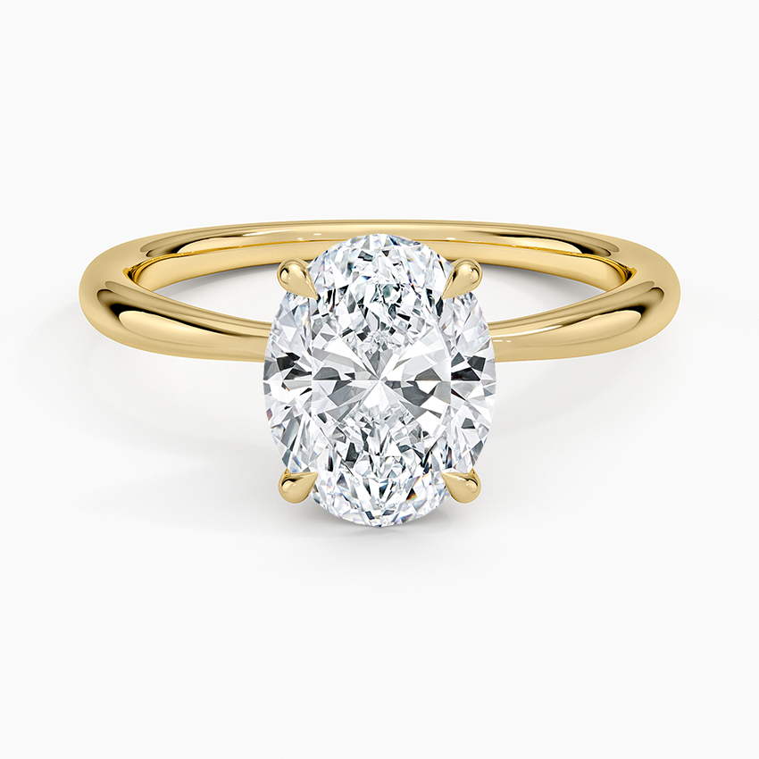 Oval cut lab grown diamond solitaire ring with a crossover shank in yellow gold, top view