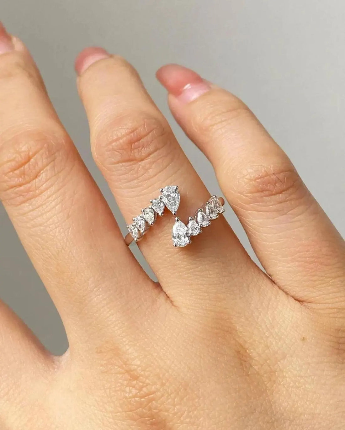 Open bypass pear cut lab grown diamond ring with graduated accents in white gold