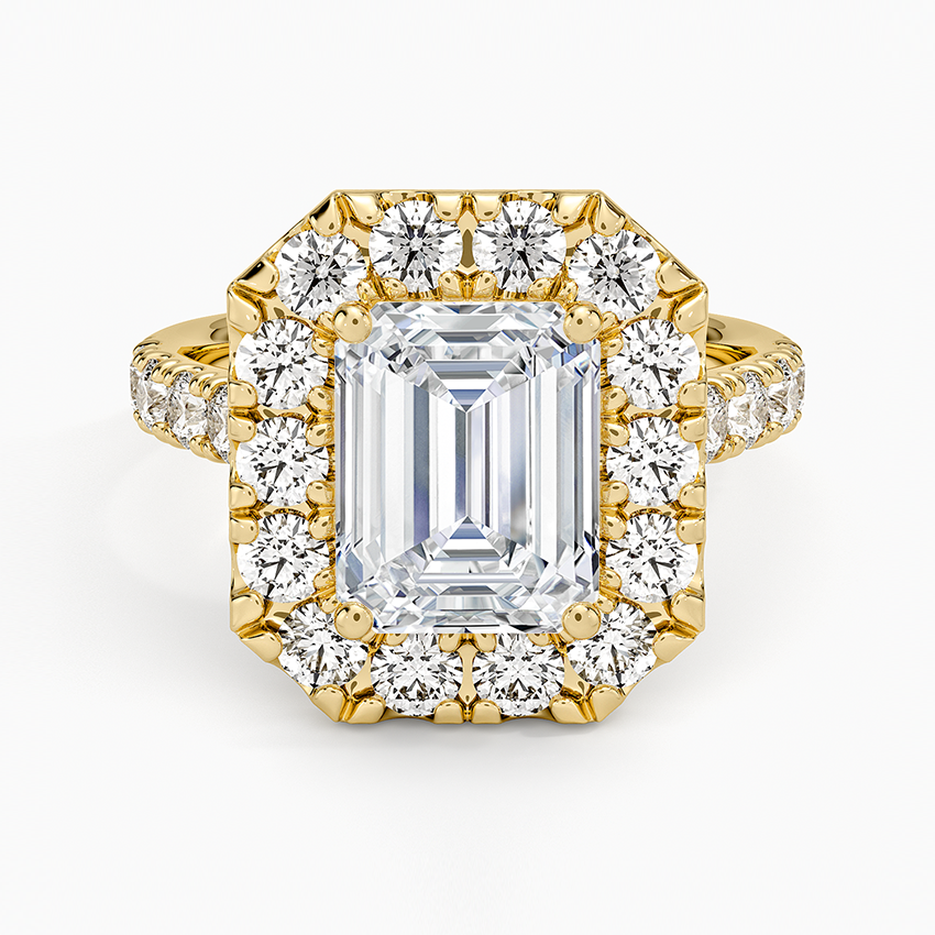 Emerald cut lab grown diamond ring in yellow gold with a bold shared prong halo and diamond set band, top view
