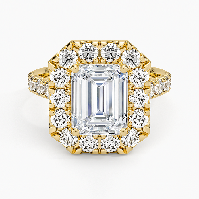 Emerald cut lab grown diamond ring in yellow gold with a bold shared prong halo and diamond set band, top view