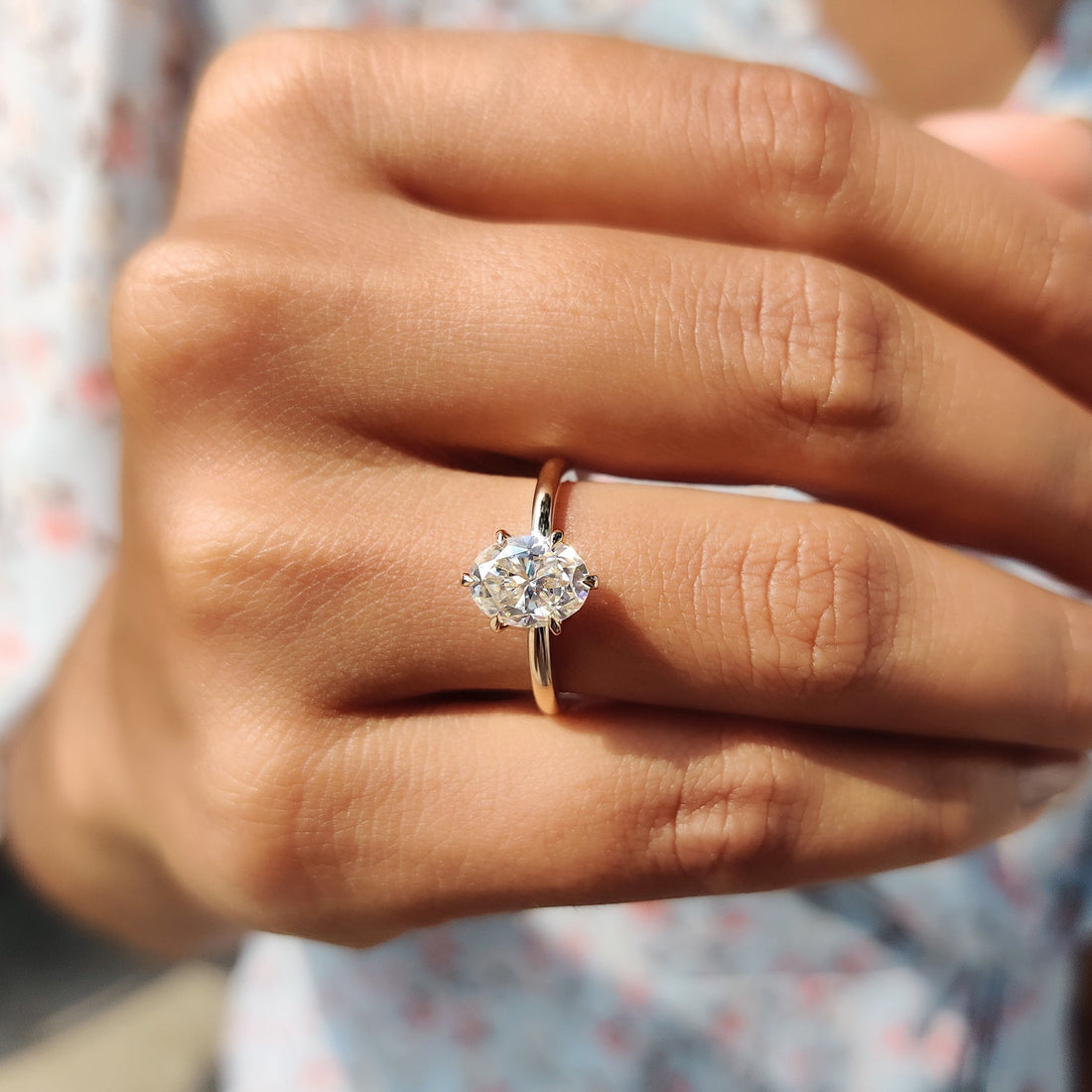 Oval cut lab grown diamond six claw solitaire worn on the hand