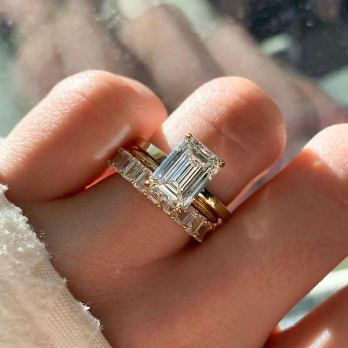 Hidden halo of round diamonds beneath the emerald cut centre stone