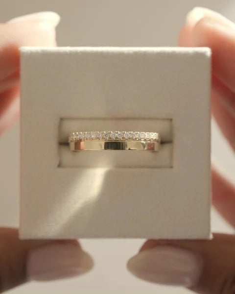 Cigar band wedding ring with pave edge diamonds