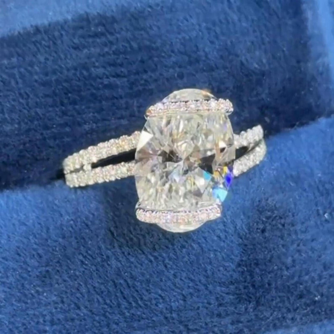 Oval cut lab grown diamond engagement ring with hidden halo on a wrapped split shank