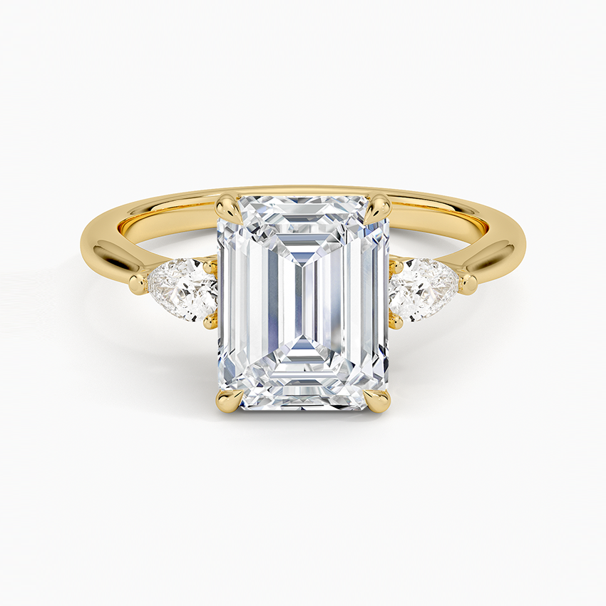 Emerald cut lab grown diamond three stone ring in yellow gold with pear side stones, top view