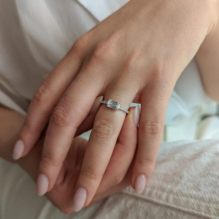 East west emerald cut lab grown diamond ring with pave band